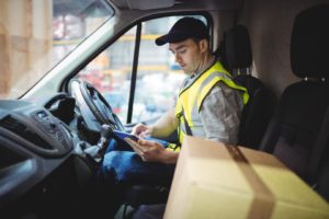 delivery-driver-sitting-in-van-using-digital-tablet