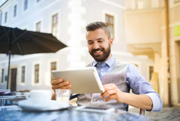 man-tablet-table-alt-Man-faxing-at-table-with-tablet