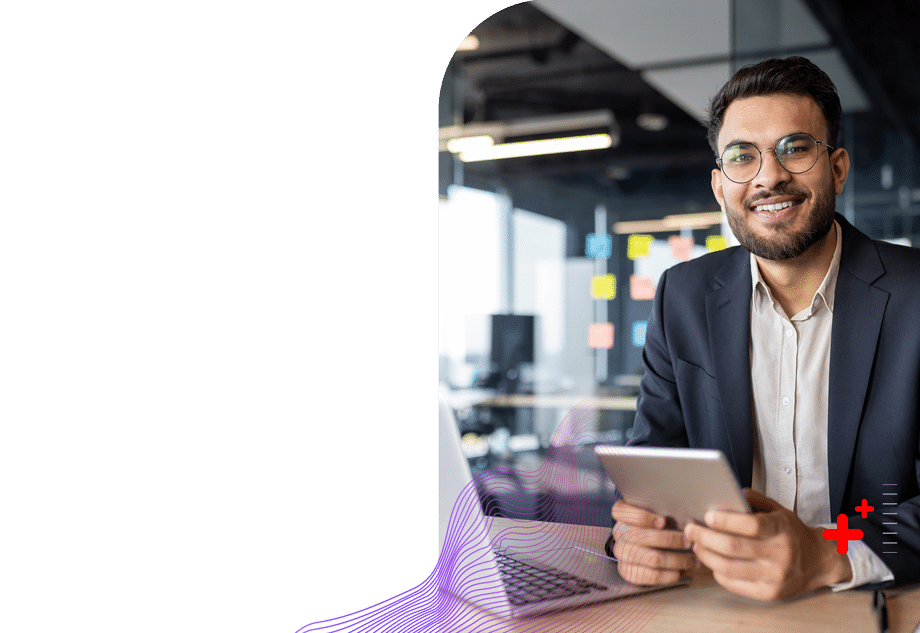 Business professional in open office setting holding tablet device.