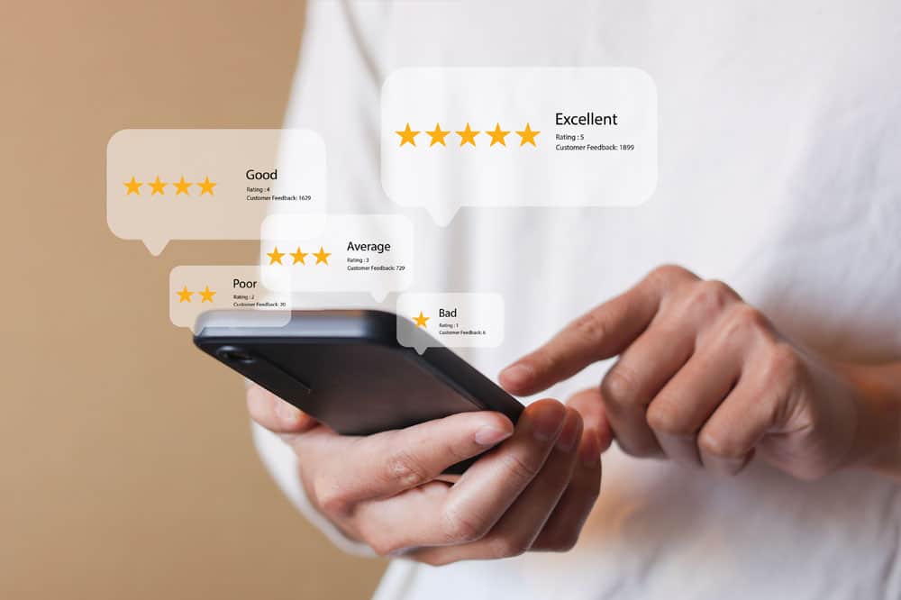 close up young man and hold smartphone and read review online website page about service and experience with many feedback and ranking score from customer for business quality and evaluation concept