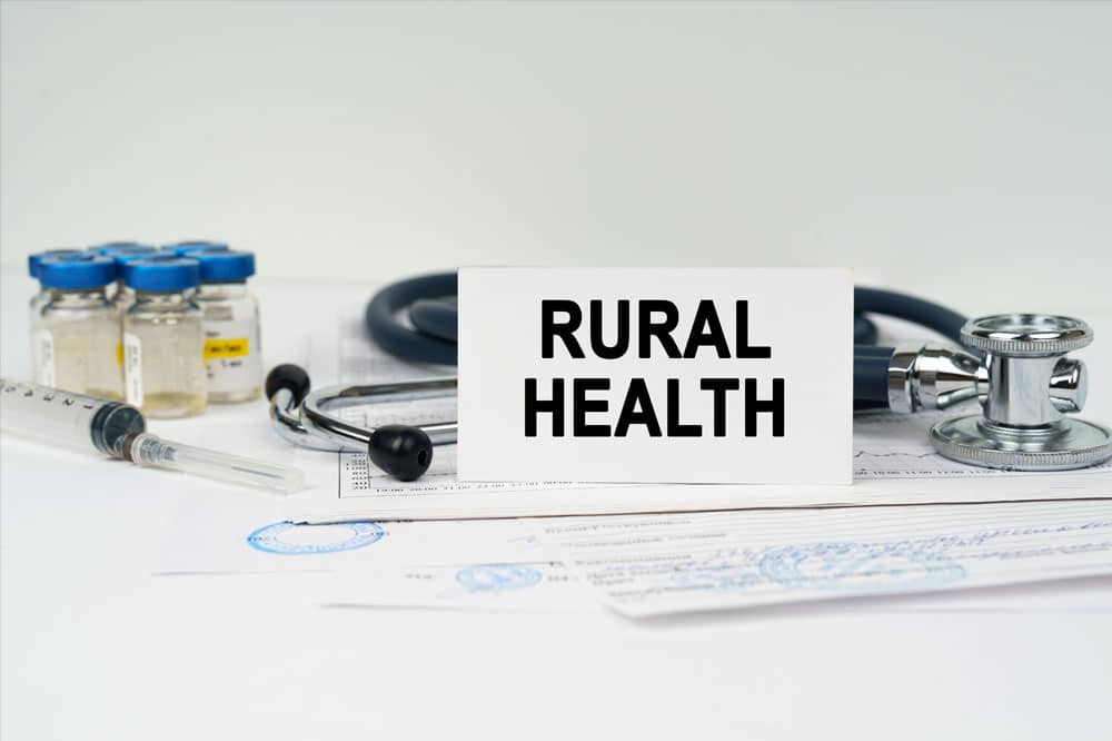 Medical documents near a stethoscope, injections, a syringe and a business card with the inscription - rural health